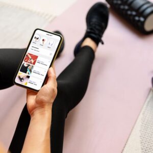 woman using a fitness app, an example of gamification in healthcare